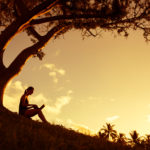 Woman working on her computer in the park.