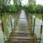 Rickety foot bridge over muddy water